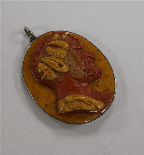 A 19th century red and yellow layered hardstone cameo carved with the head of a satyr, in pendant mount, 38mm.